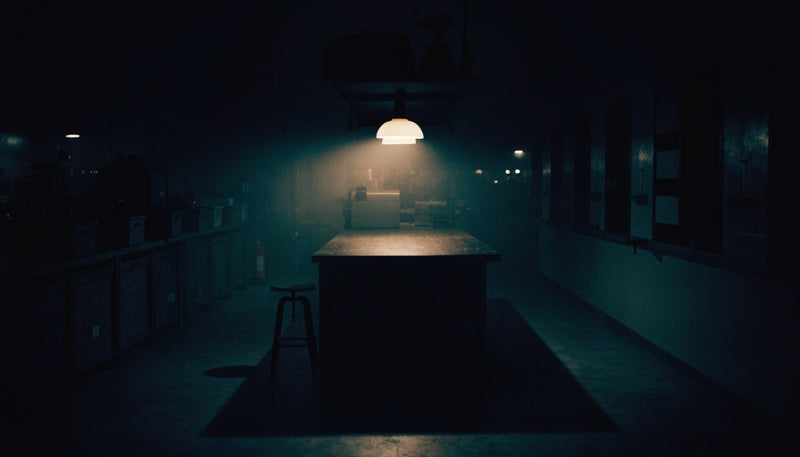A dimly lit workshop counter at night — editorial illustration (AI-generated)