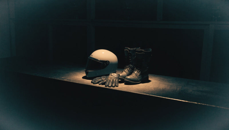 A complete set of motorcycle gear waiting together on a shelf — editorial illustration (AI-generated)