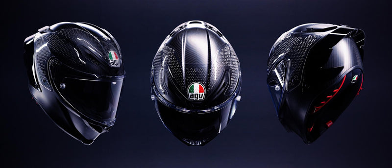 Three AGV Pista GP R3 helmets on a dark stage