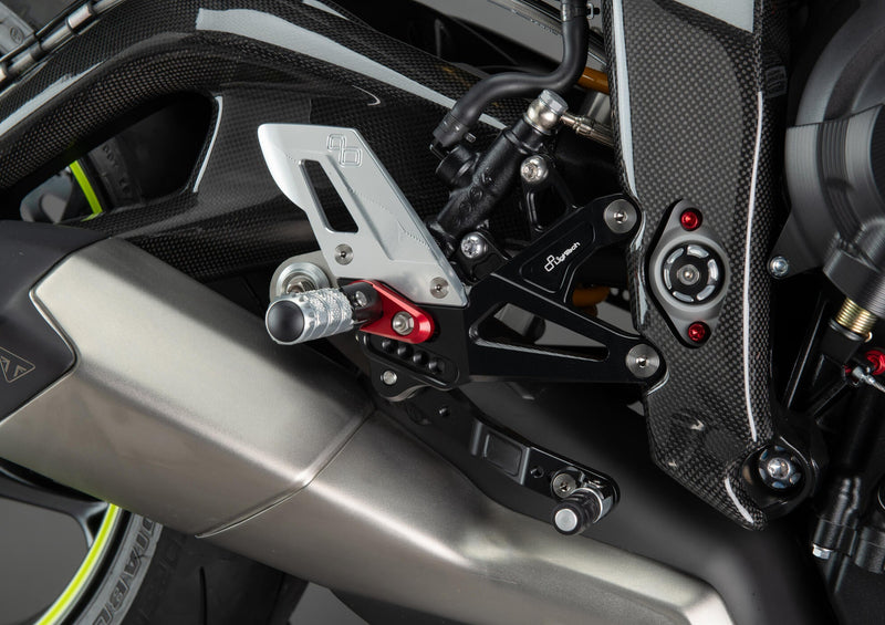 LighTech FTRTR005R rearset system for Triumph Street Triple 765 – red carriers, carbon heel guards, silver folding pegs