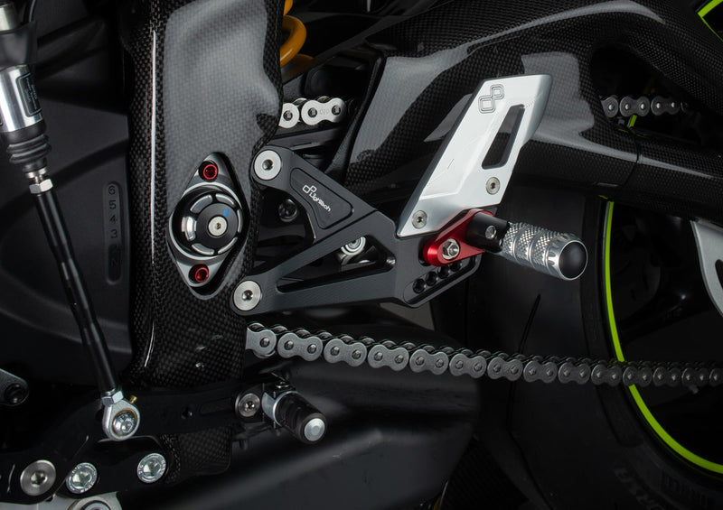 LighTech FTRTR005R rearset system for Triumph Street Triple 765 – red carriers, carbon heel guards, silver folding pegs