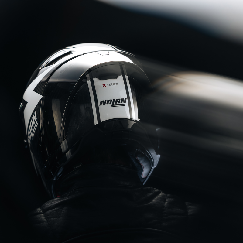 Nolan X-804 RS Ultra Carbon helmet Dom Herbertson Replica aquamarine white 382 – rear three-quarter action shot